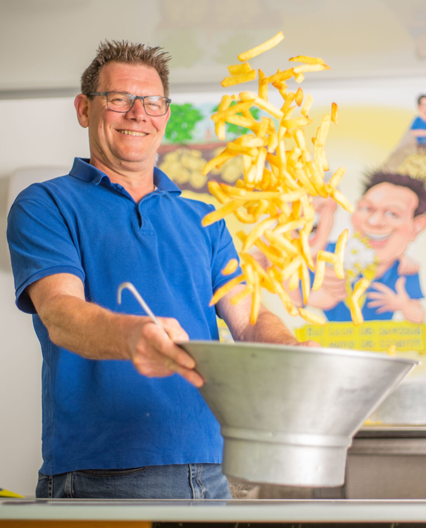 Frietbakker die friet aan het maken is